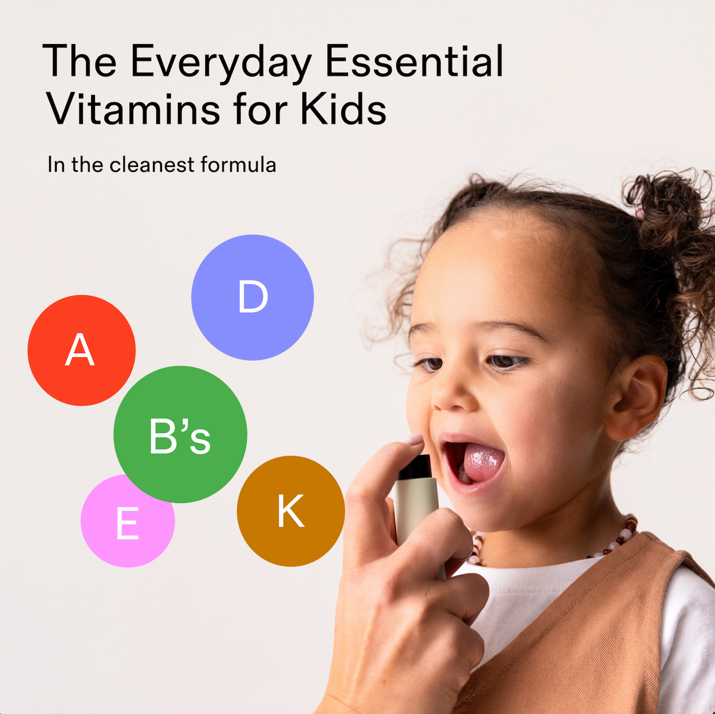 Parent spraying the vitamin spray to kid with infographic of vitamins inside the sprays: A, B vitamines, D, E, K.